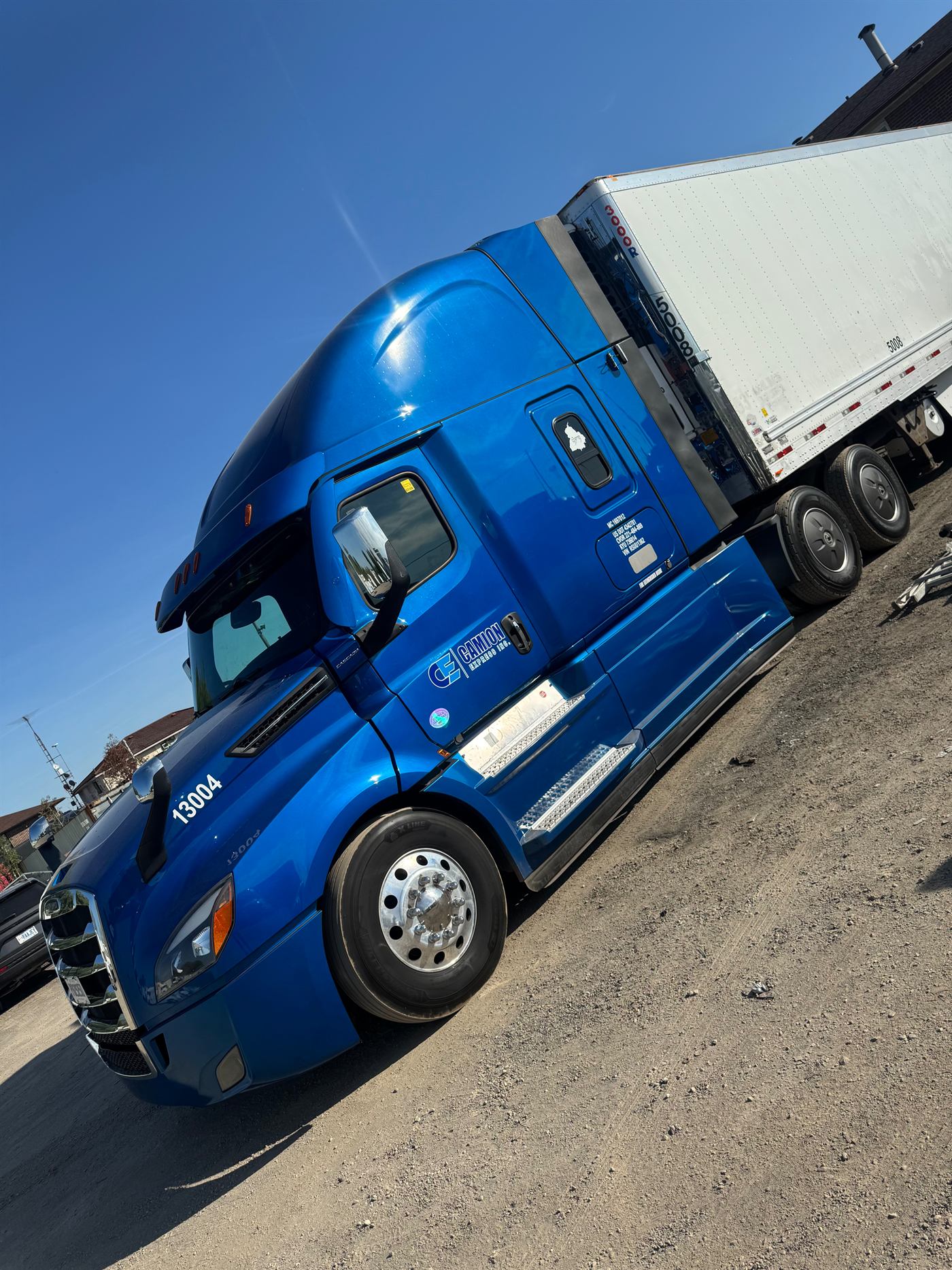 Front three-quarter view of Camion Express unit 13004, a blue Freightliner Cascadia